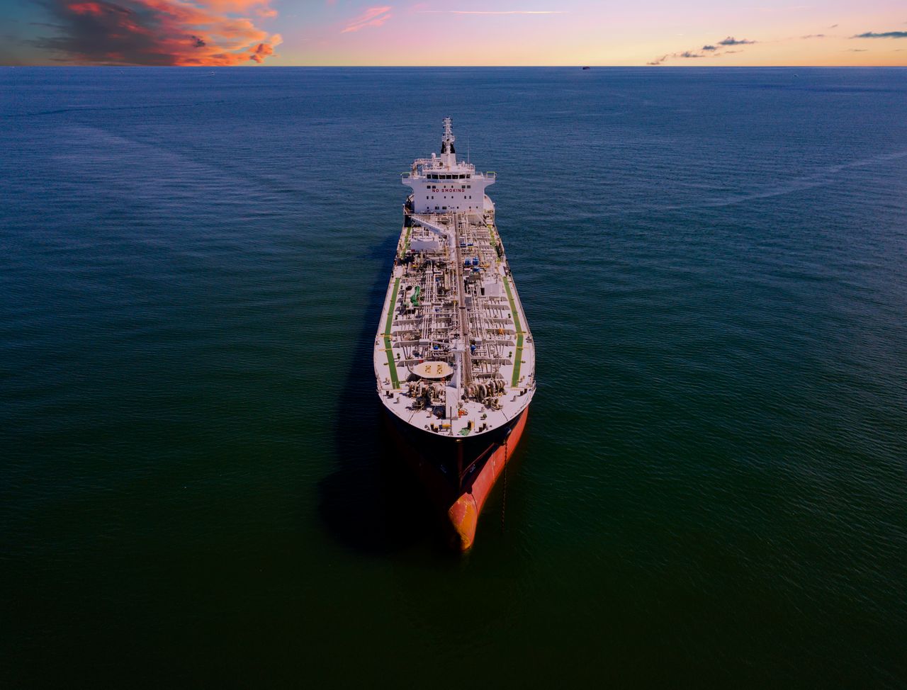 Home Aerial shot of an oil tanker on the ocean at sunset in Galveston, Texas.